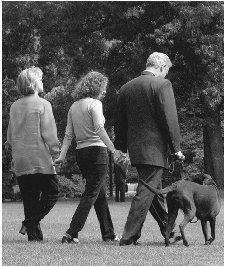 President Clinton and his family, along with dog Buddy, walk across the south lawn of the White House in 1998. AP/WIDE WORLD